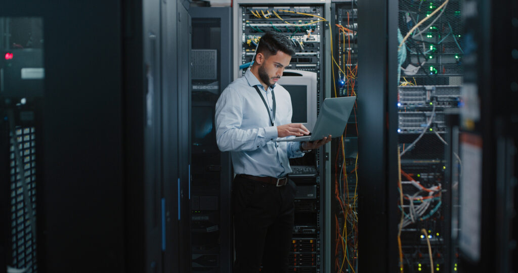As an IT service provider in Michigan, Nordicom Technologies provides a wide array of solutions. This is an image of an IT professional in a server room.
